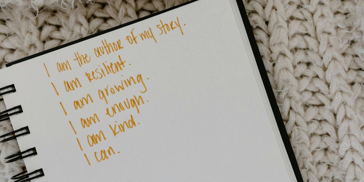 Job seeker writing quotes in notebook