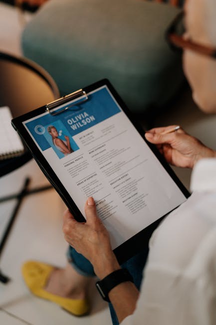 Recruiter analyzing a candidate’s resume at desk