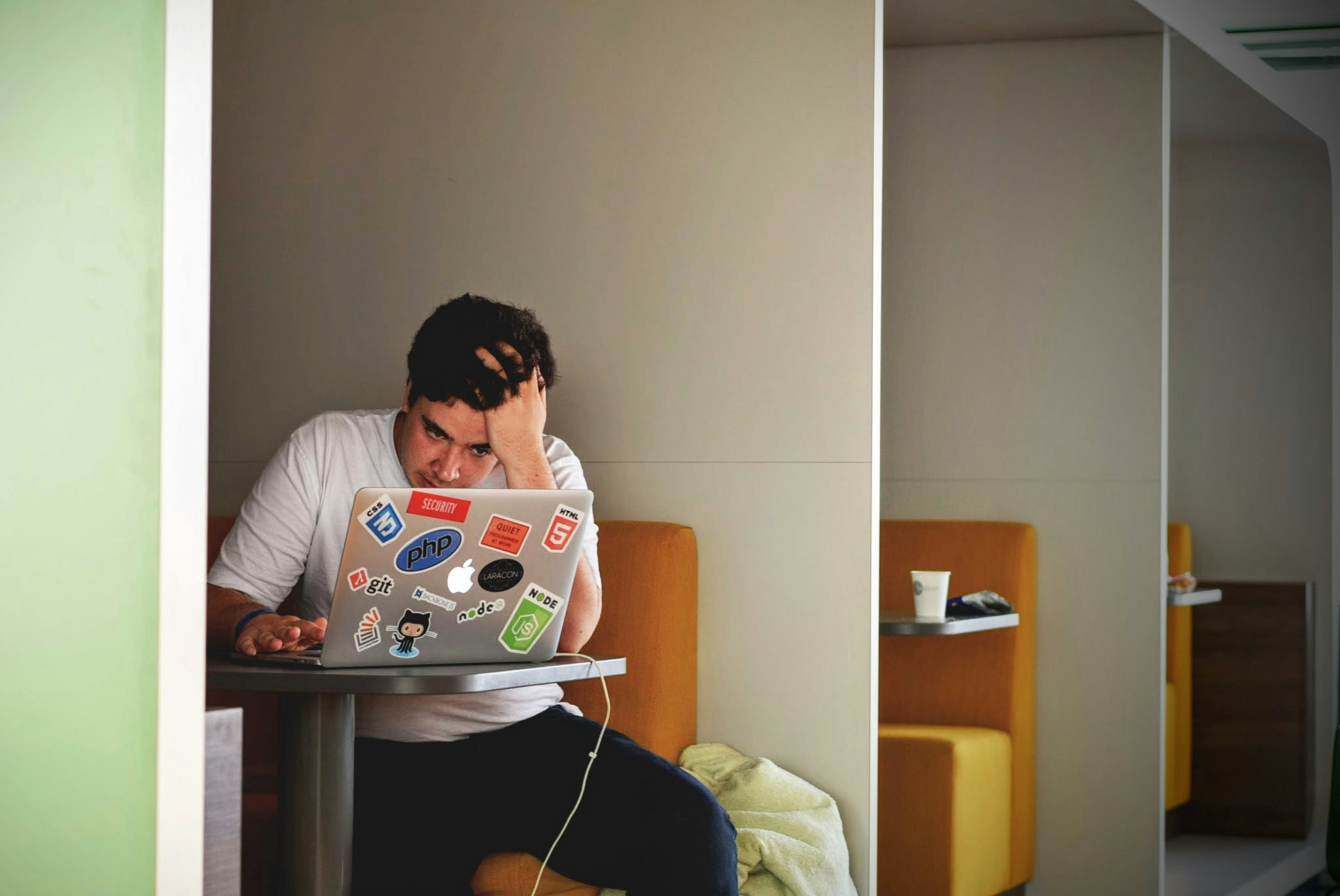 A stressed student sitting at a laptop
